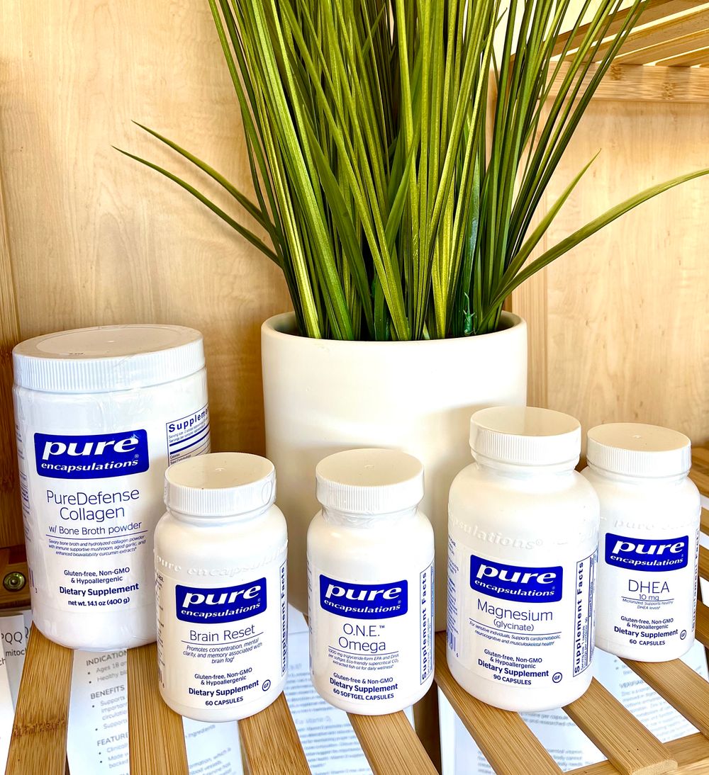Pure Encapsulations vitamins and supplements on a wooden shelf